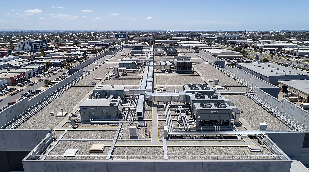 Commercial rooftop packaged AC units installed on roof curb